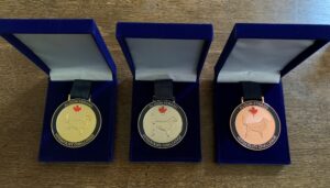 3 medals in cases for the Alison Strang winners.